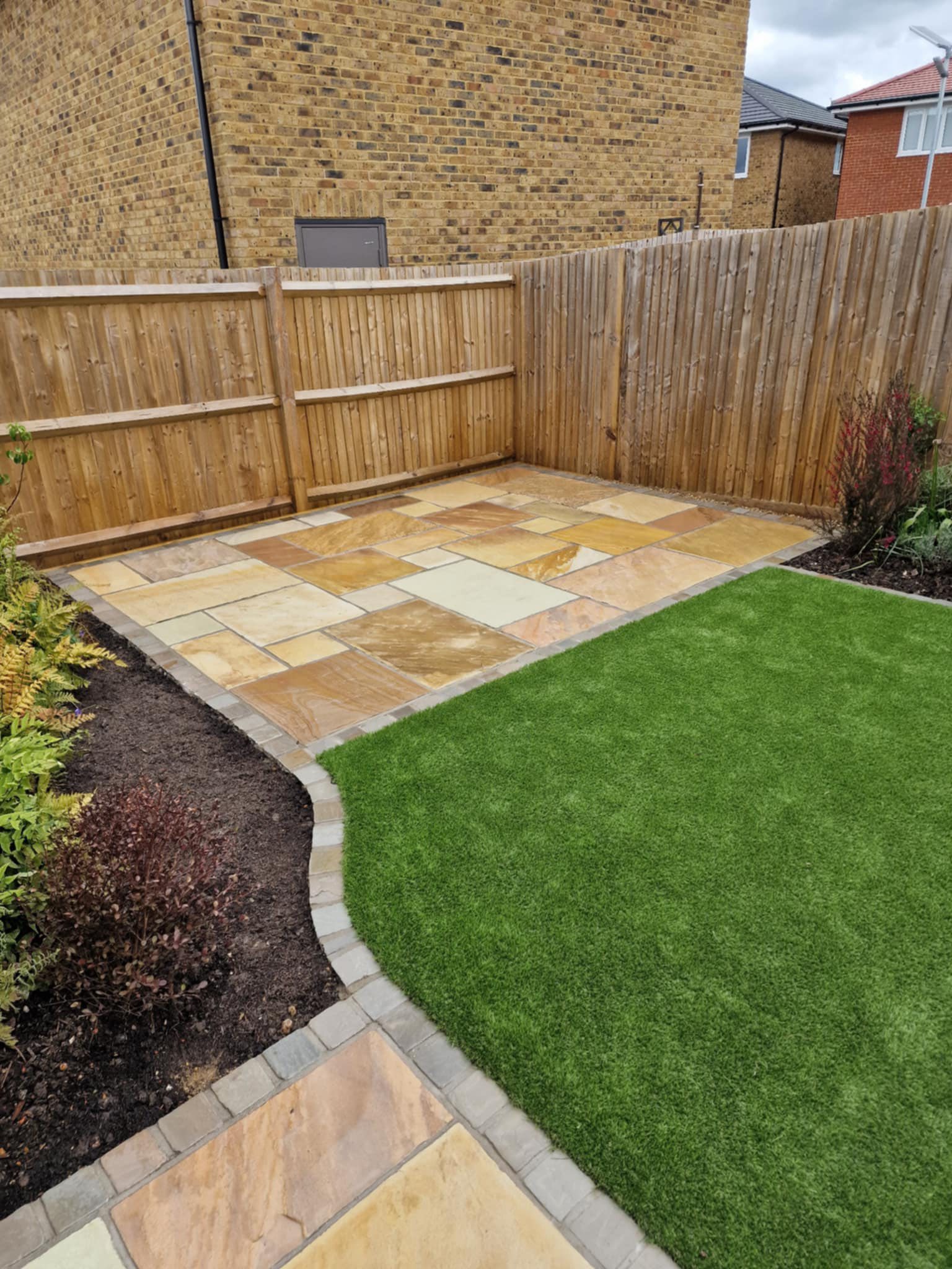 Lawn re-turfing landscaping and new tile patio
