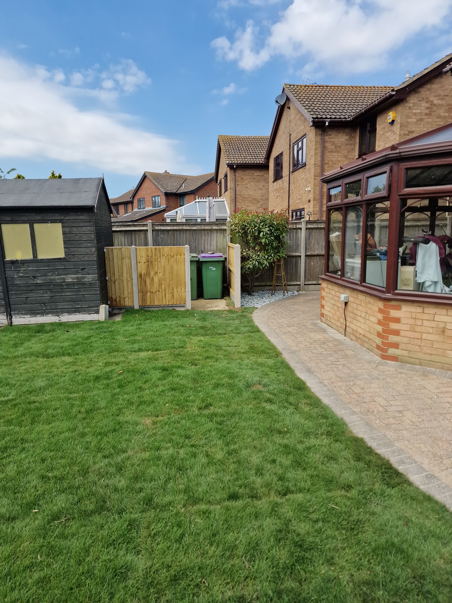 Lawn re-turf and patio installation and fenced recycling area