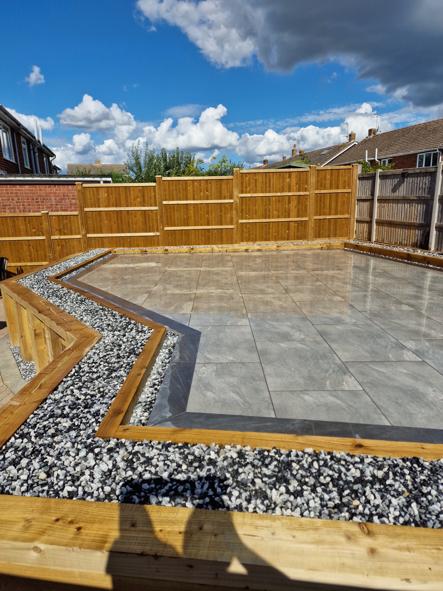 Raised timber-edged backyard patio Ashford, Kent